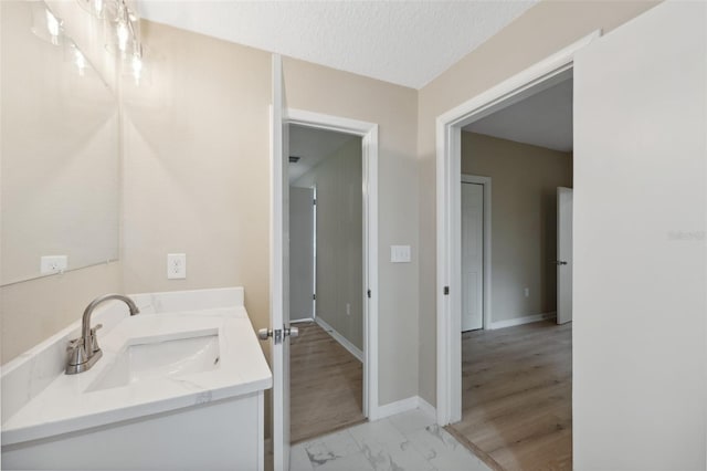 bathroom featuring a textured ceiling and vanity