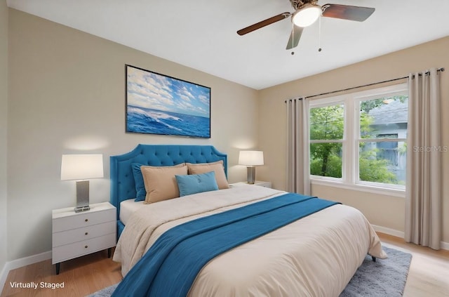 bedroom with light hardwood / wood-style floors and ceiling fan