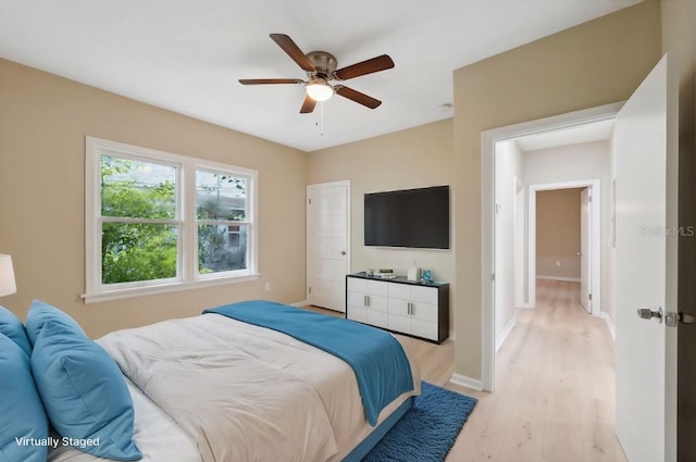 bedroom with ceiling fan and light hardwood / wood-style floors