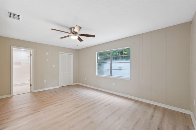 spare room featuring ceiling fan and light hardwood / wood-style flooring