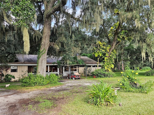 view of front of property with a front lawn and a carport