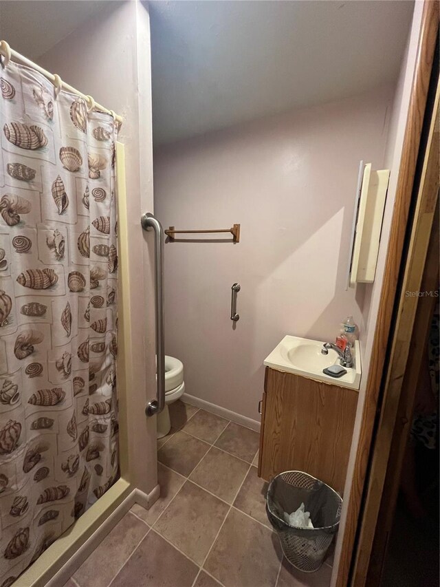 bathroom featuring tile patterned floors, vanity, and toilet