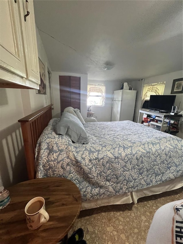 bedroom featuring white refrigerator