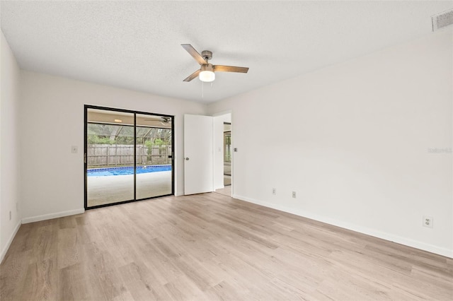 unfurnished bedroom featuring ceiling fan, a textured ceiling, light wood-type flooring, and access to exterior