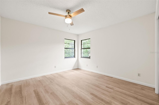 empty room featuring light hardwood / wood-style flooring, a textured ceiling, and ceiling fan