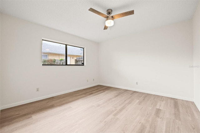 spare room with ceiling fan and light wood-type flooring