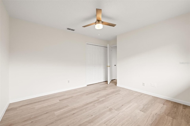 unfurnished bedroom with ceiling fan and light hardwood / wood-style floors