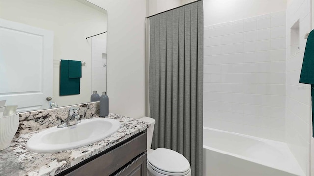 full bathroom with vanity, shower / bathtub combination with curtain, and toilet