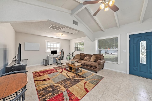 living room with ceiling fan, a textured ceiling, light tile patterned floors, and vaulted ceiling with beams