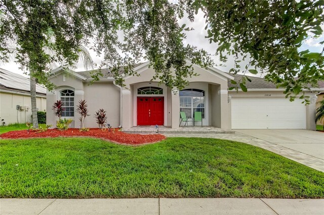 single story home featuring a garage and a front lawn