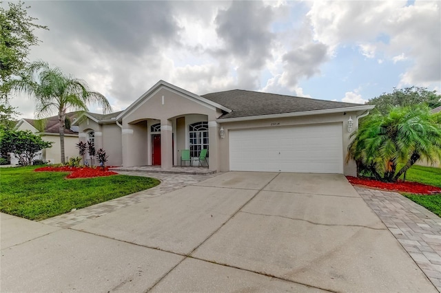 single story home featuring a garage and a front yard