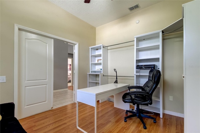 office space with light hardwood / wood-style flooring and a textured ceiling