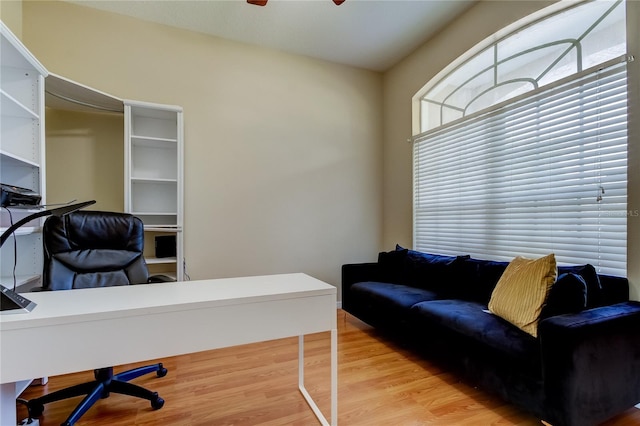 office with ceiling fan and light wood-type flooring