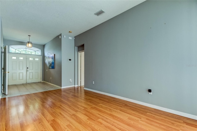 entryway featuring light hardwood / wood-style flooring and a textured ceiling