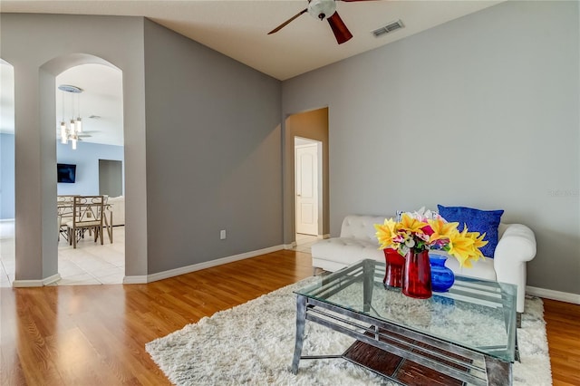 living room featuring ceiling fan and light wood-type flooring