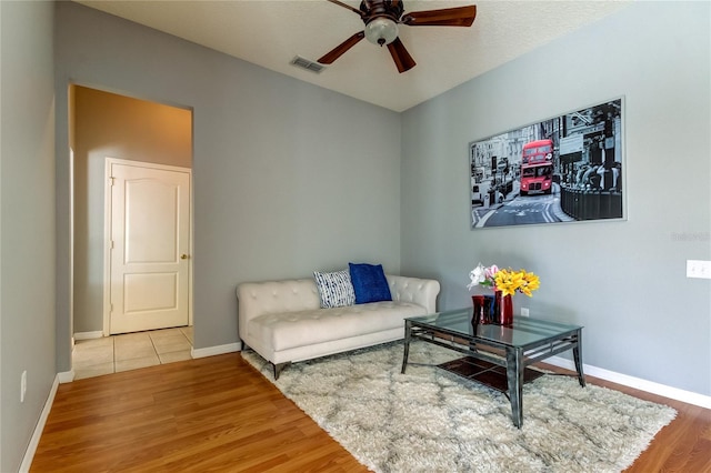 living room featuring ceiling fan and light hardwood / wood-style flooring