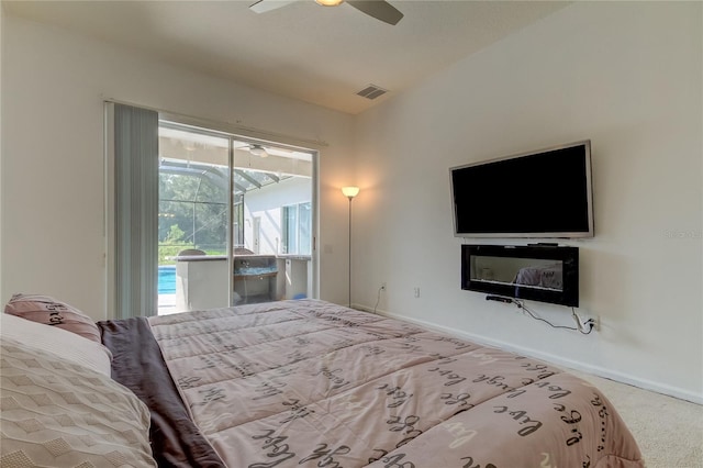 carpeted bedroom featuring ceiling fan and access to exterior