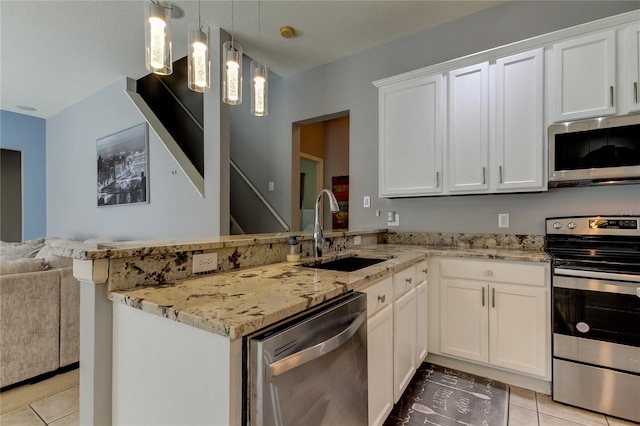 kitchen featuring appliances with stainless steel finishes, kitchen peninsula, light stone countertops, light tile patterned floors, and sink