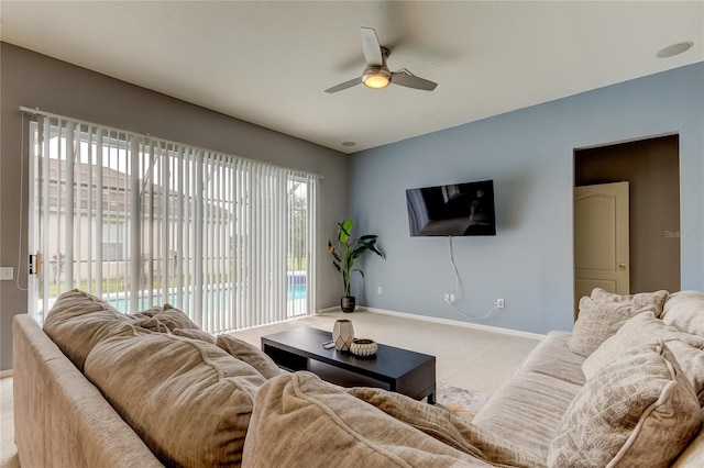 carpeted living room featuring ceiling fan