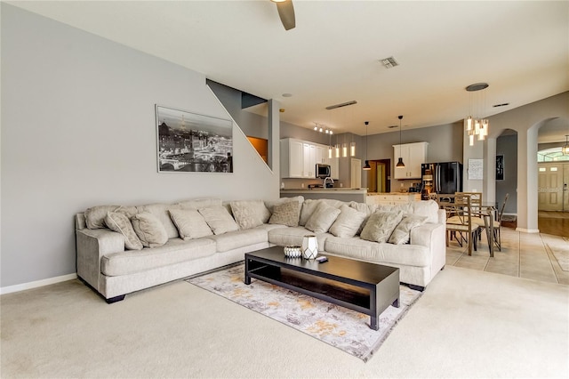 living room with ceiling fan and light colored carpet