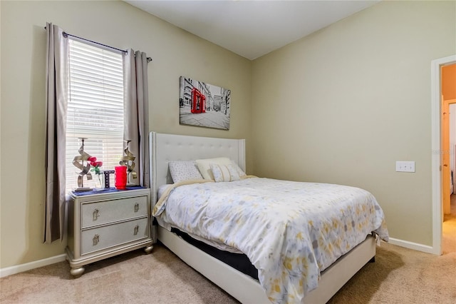 bedroom with light carpet and multiple windows