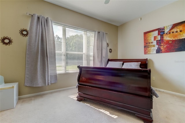 bedroom with ceiling fan, carpet flooring, and multiple windows