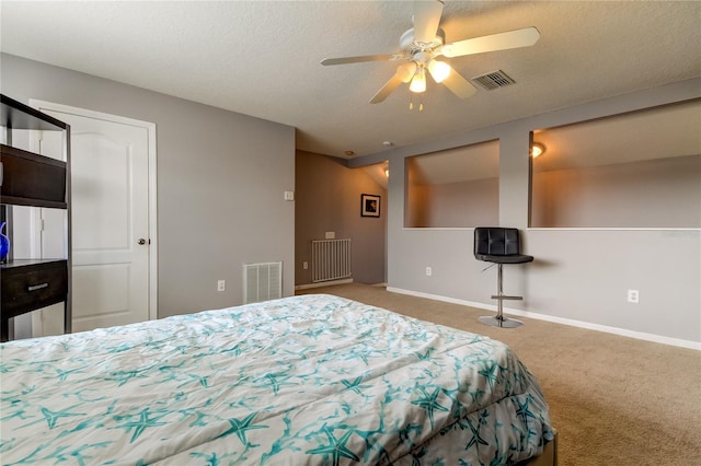 bedroom featuring ceiling fan, carpet flooring, and a textured ceiling