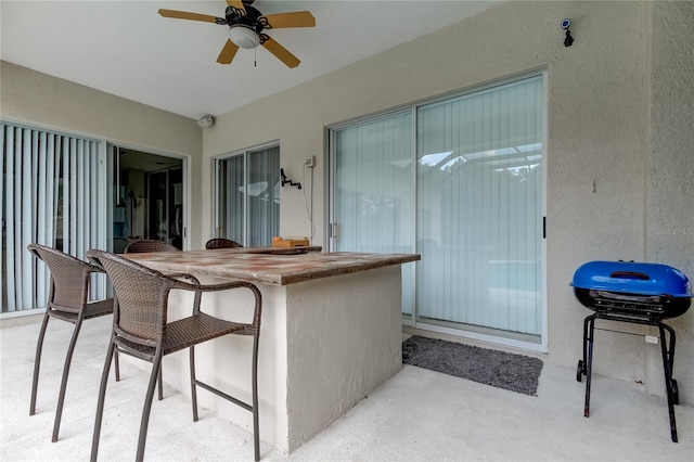 view of patio featuring ceiling fan