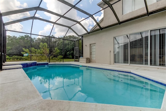 view of pool with glass enclosure