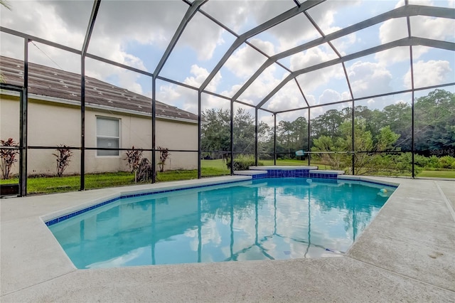 25954 Risen Star Dr, Wesley Chapel, FL 33544 - view of swimming pool with pool water feature, glass enclosure, and a patio area