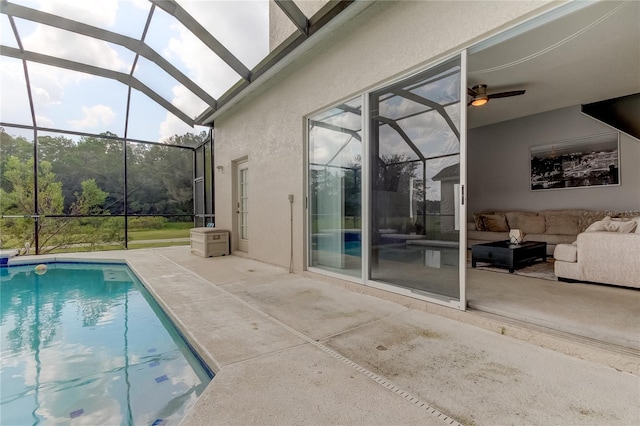 view of pool featuring glass enclosure and a patio area