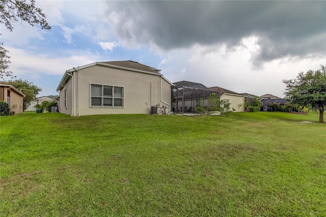 25954 Risen Star Dr, Wesley Chapel, FL 33544 - exterior space featuring a lanai, a yard, and cooling unit