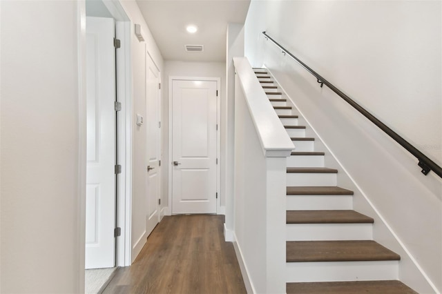 staircase featuring wood-type flooring