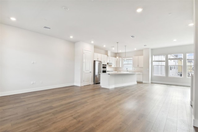 unfurnished living room featuring wood-type flooring