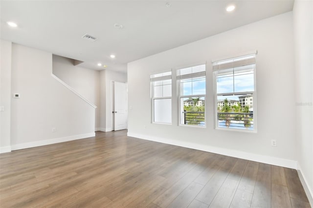 unfurnished room with dark hardwood / wood-style floors