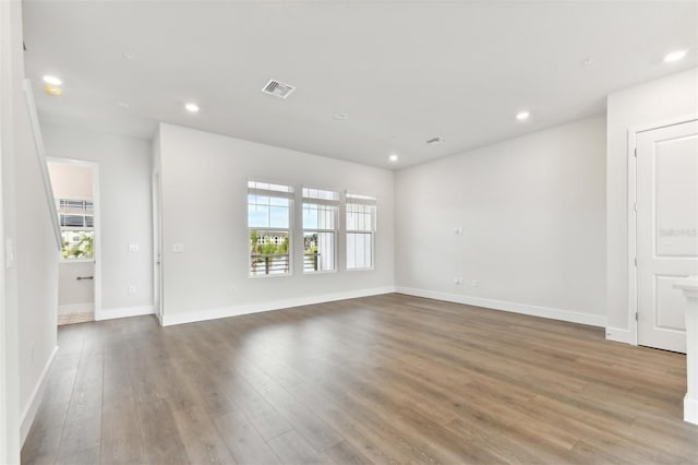 unfurnished room with hardwood / wood-style flooring