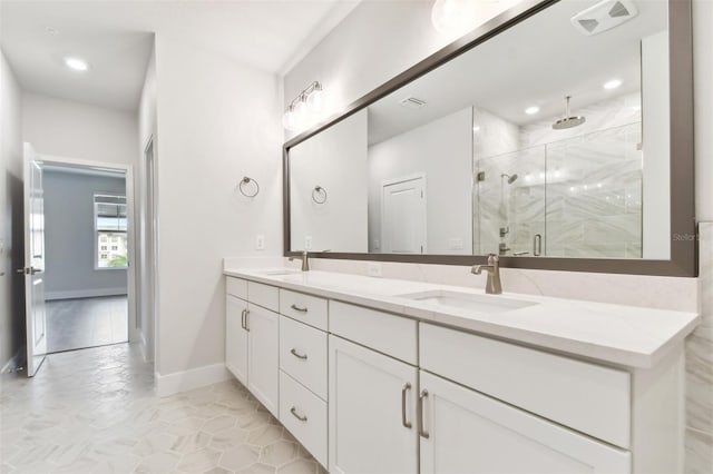 bathroom with tile patterned floors, a shower with door, and vanity