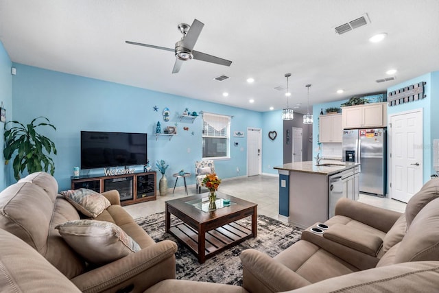 living room featuring ceiling fan and sink