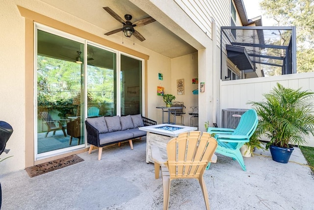 view of patio / terrace with central AC, an outdoor fire pit, and ceiling fan