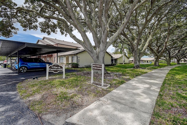 view of front of property with a carport and a front yard