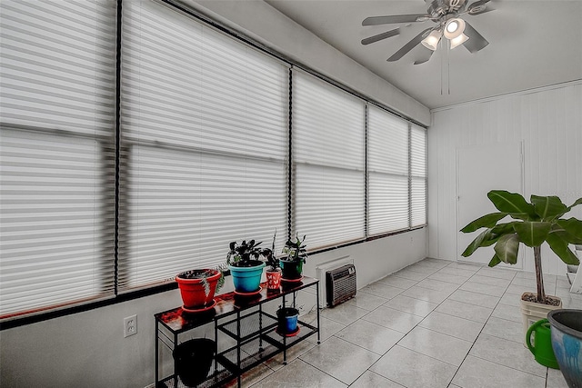 sunroom featuring ceiling fan