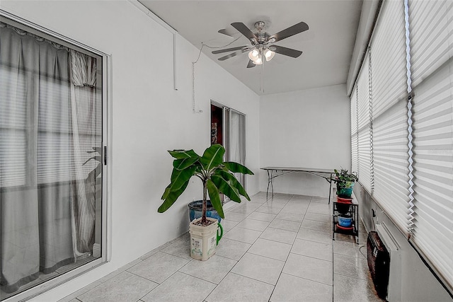 unfurnished sunroom featuring ceiling fan