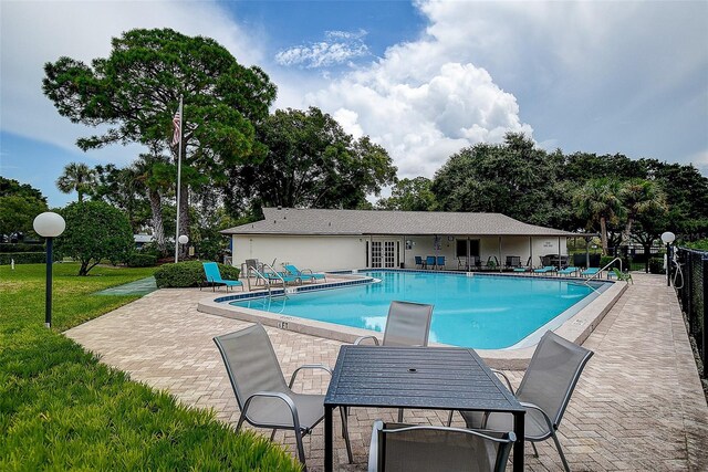 view of swimming pool featuring a lawn and a patio