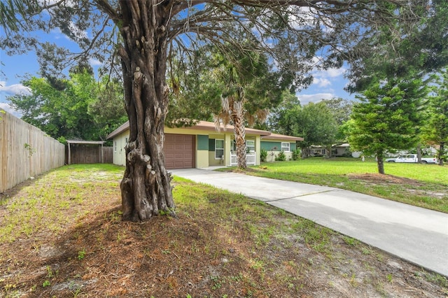 ranch-style home with a front lawn and a garage