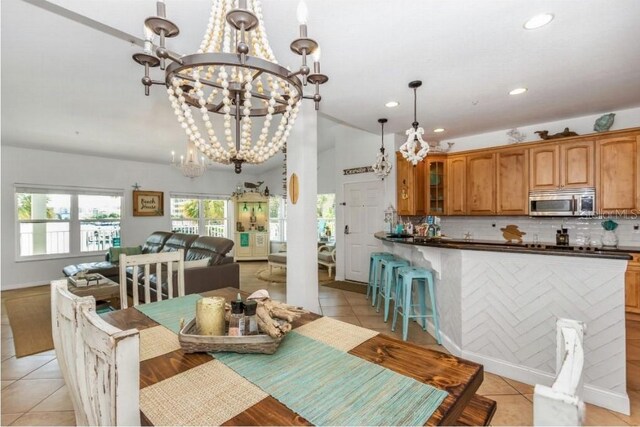 dining room with a notable chandelier and light tile patterned flooring