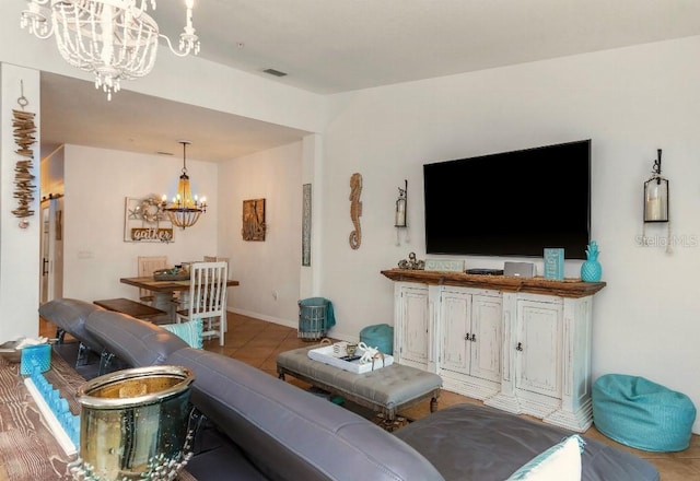 living room with a chandelier and light tile patterned floors