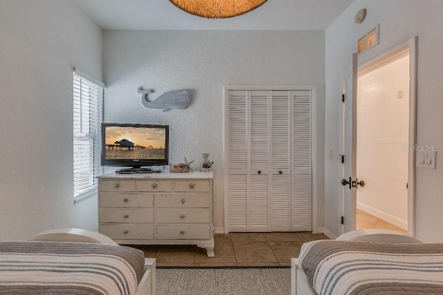 bedroom featuring a closet and light tile patterned floors