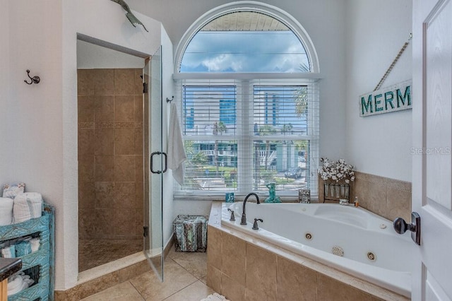 bathroom featuring an enclosed shower, a healthy amount of sunlight, and tile patterned floors