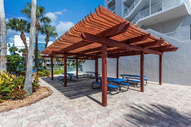 view of property's community with a pergola and a patio