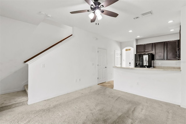 unfurnished living room with light carpet and ceiling fan